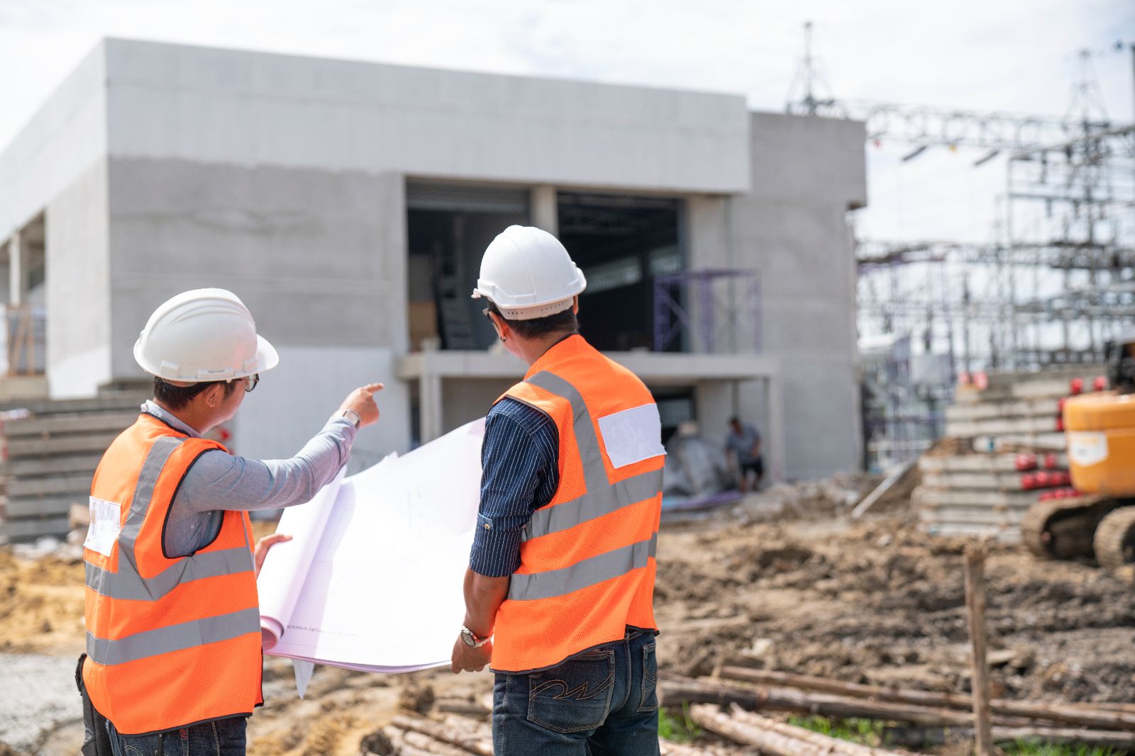 Construction engineers discussion with architects at constructio