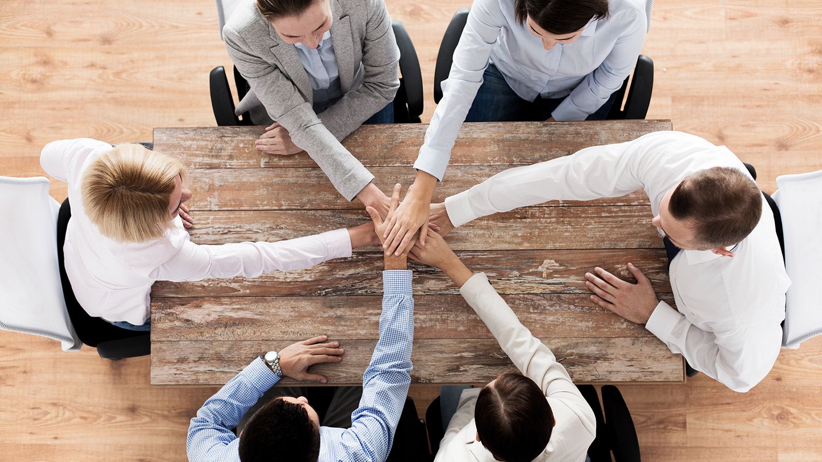 close up of business team with hands on top